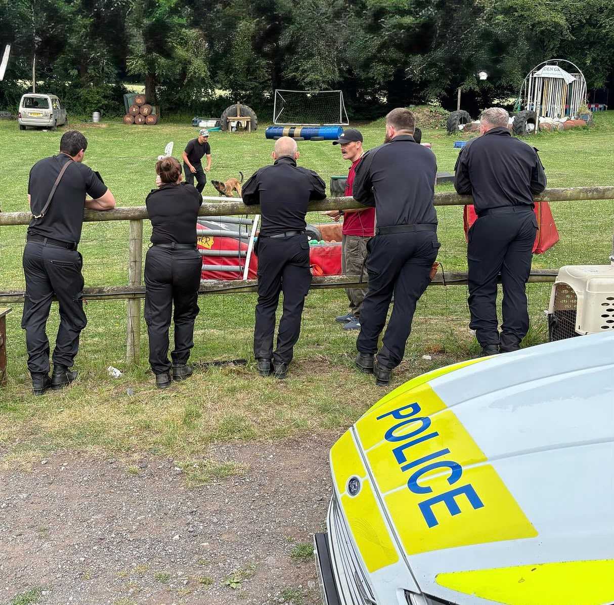 Security team watching a dog worked on a training day at Woodborough