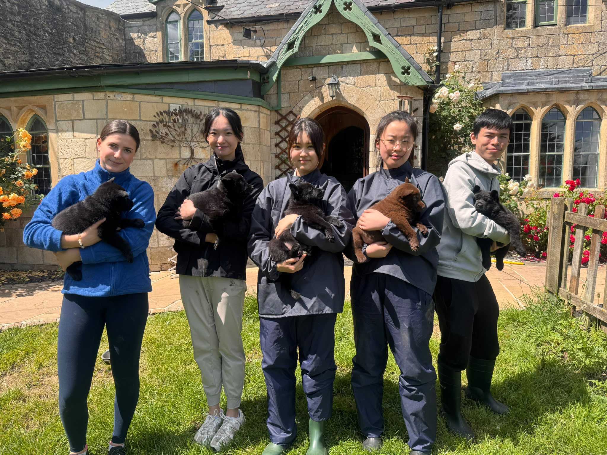 Level 3 Animal Management students each holding a puppy at Woodborough